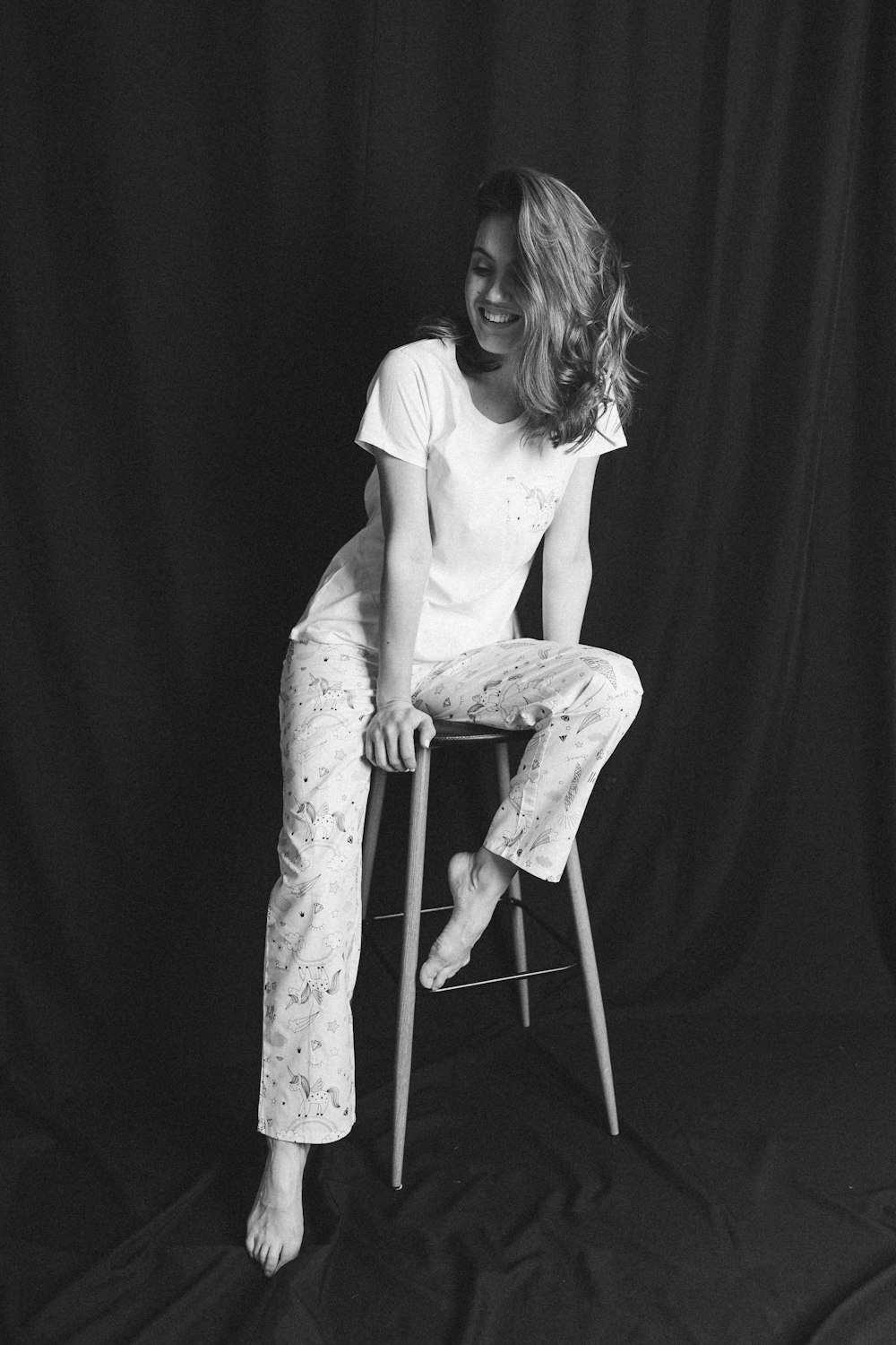 a woman sitting on top of a wooden chair