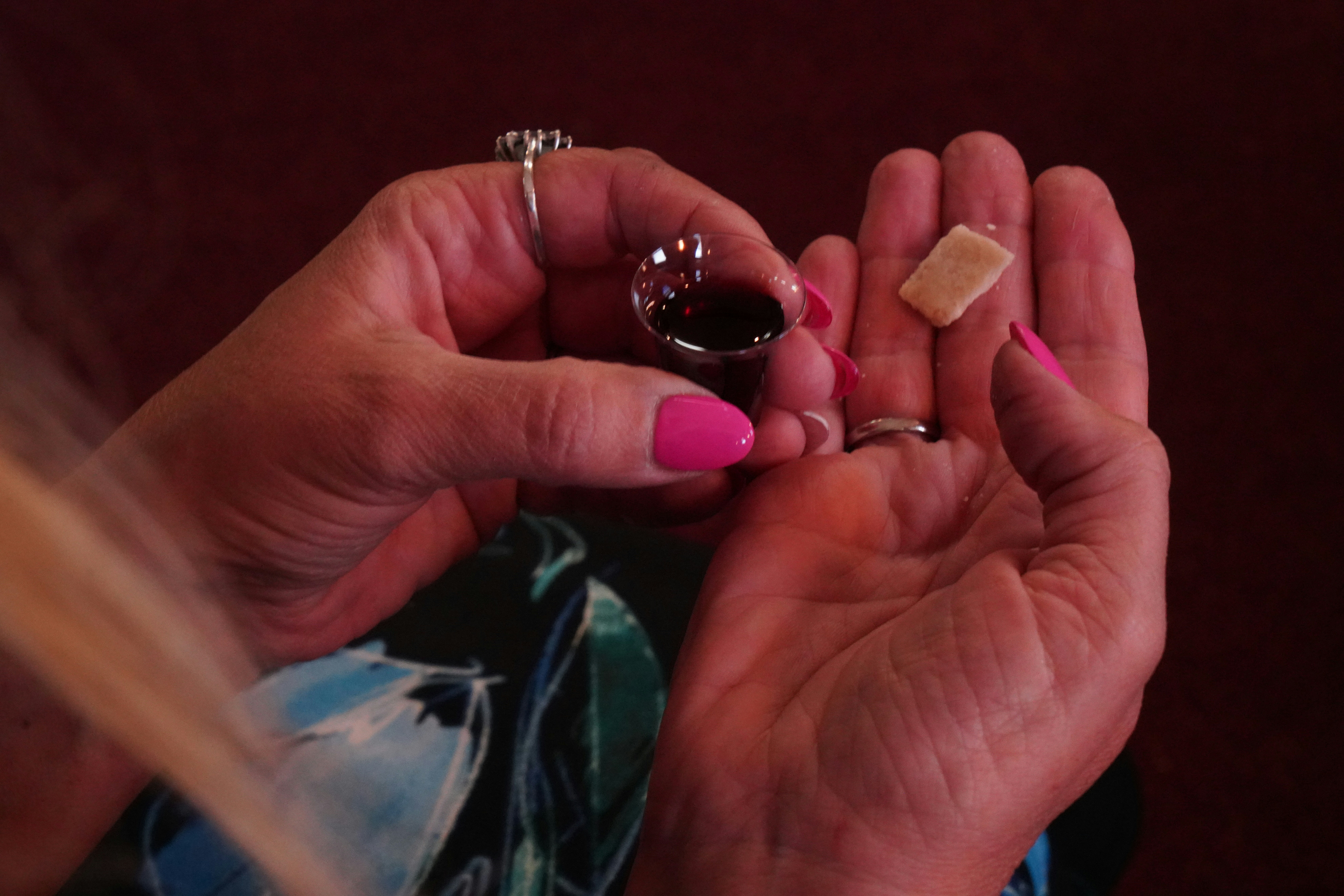 a woman is holding a small piece of food in her hands