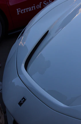 Close-up of a sleek sports car hood polished to a mirror finish with éclatauto&amp;amp;amp;amp;amp;amp;amp;amp;amp;#x27;s paint protection film