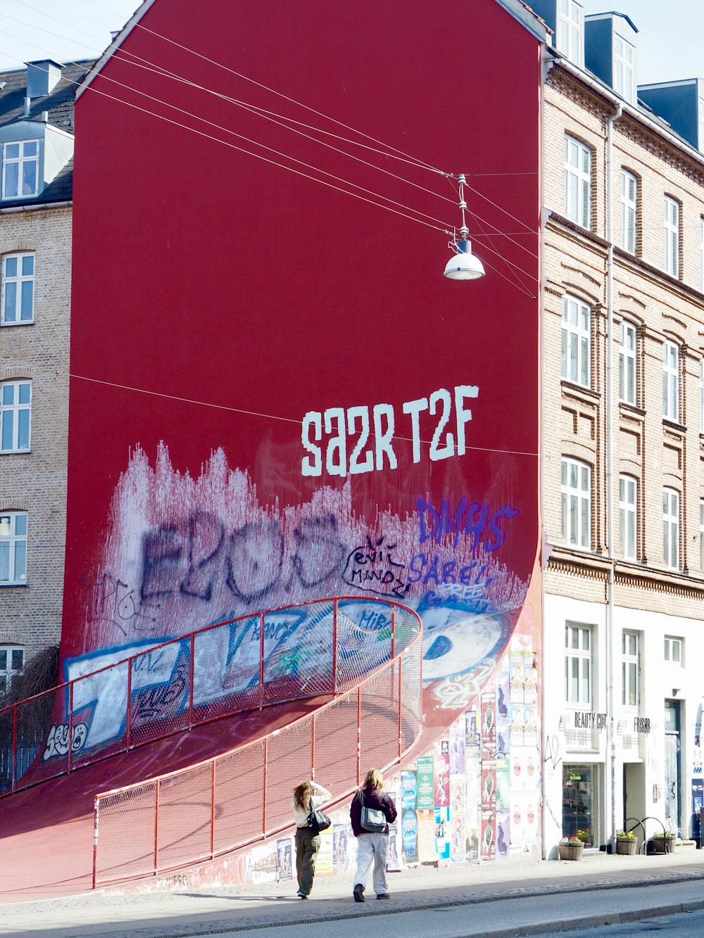 a large red building with graffiti on the side of it
