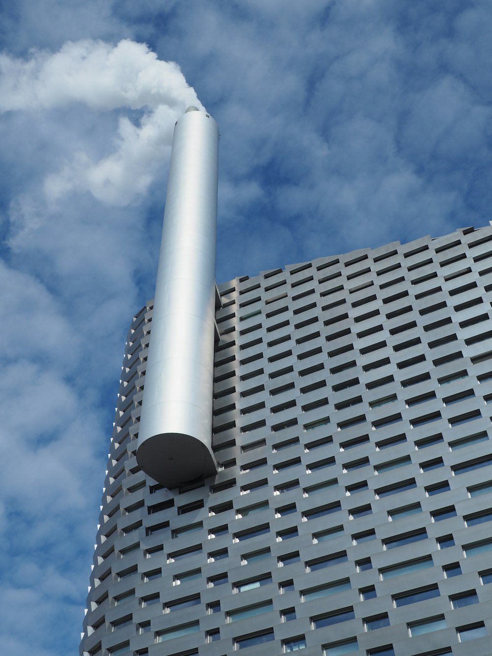 a tall building with a metal pipe sticking out of it's side
