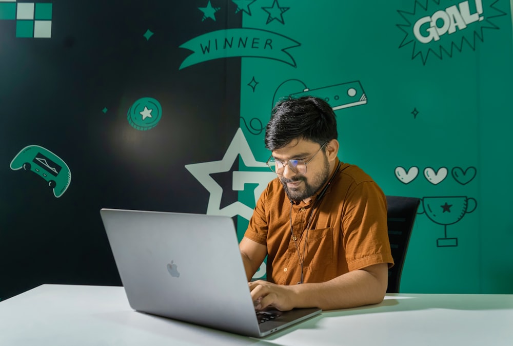 a man sitting in front of a laptop computer