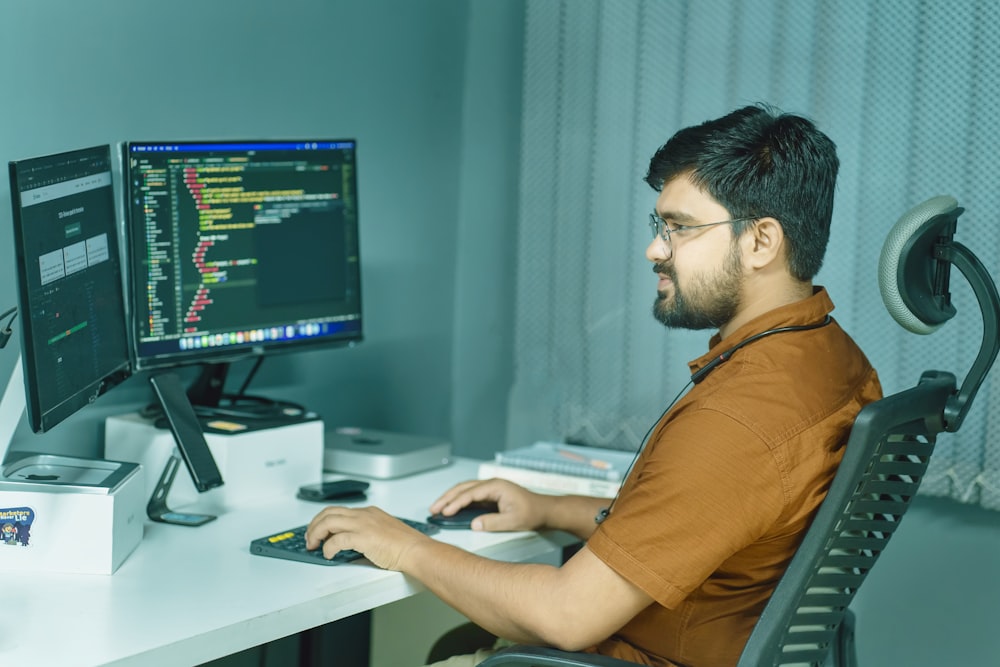 a man sitting at a desk using a computer