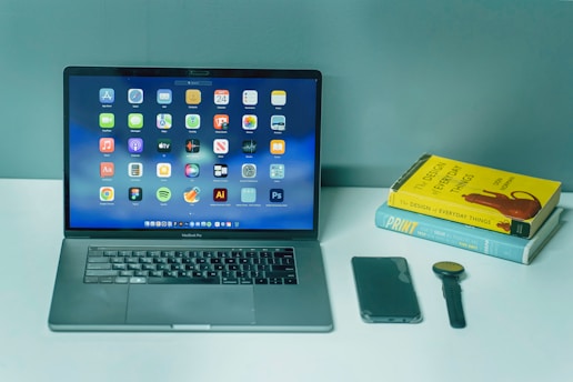 a laptop computer sitting on top of a white desk
