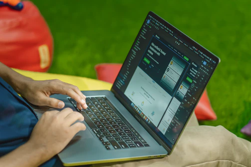 A friendly person typing on a laptop with internship-related icons floating around.
