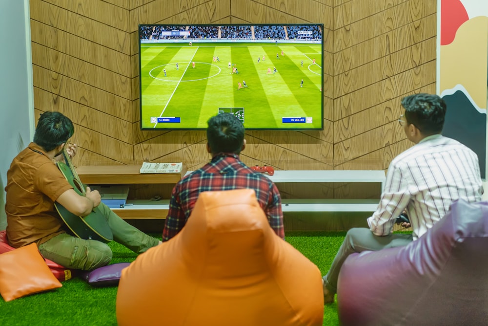a group of people sitting in front of a flat screen tv