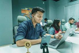 a man sitting in front of a laptop computer