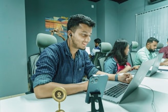 a man sitting in front of a laptop computer