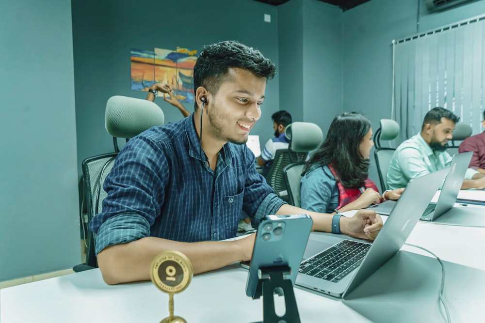 a man sitting in front of a laptop computer