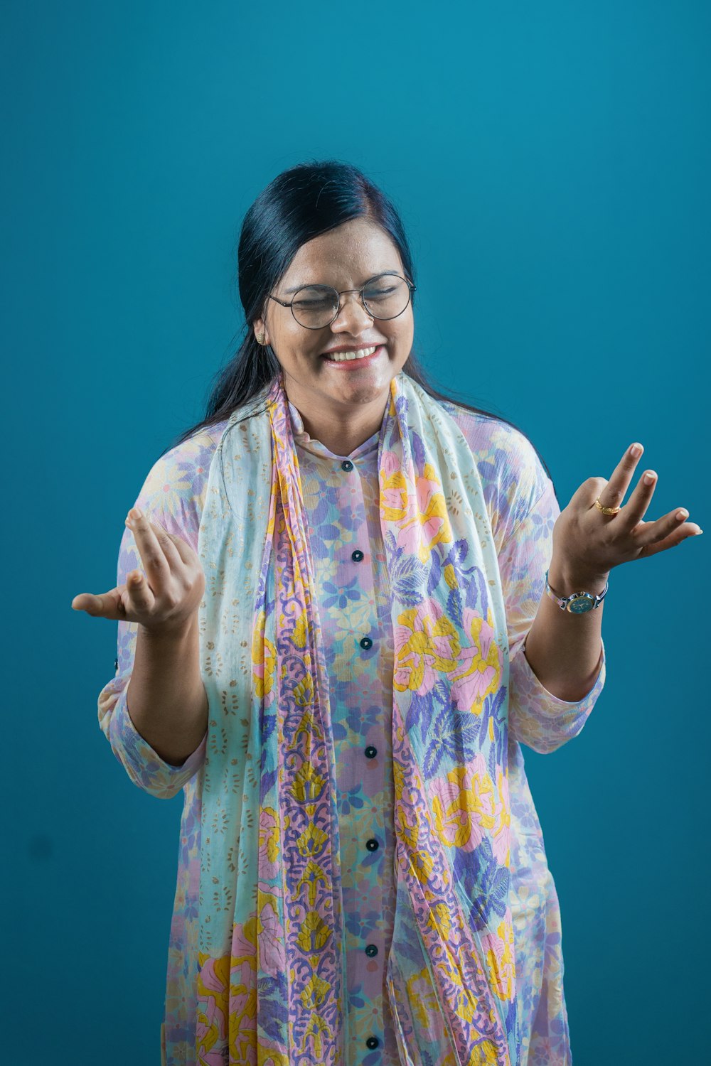 a woman wearing glasses and a colorful scarf