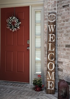 Close-up of a welcome sign on a front door of a home.