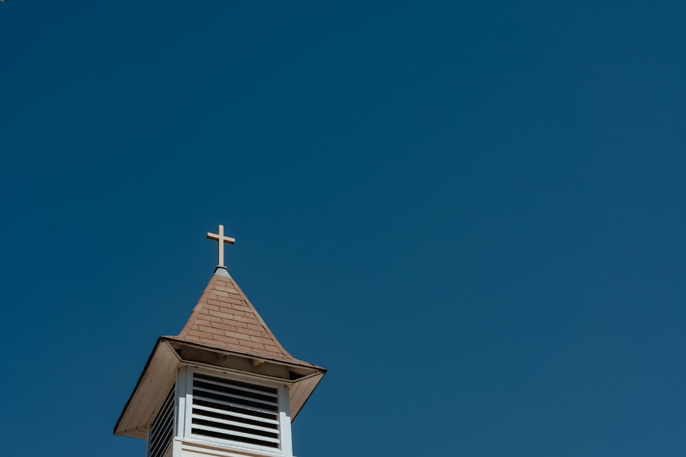 a church steeple with a cross on top