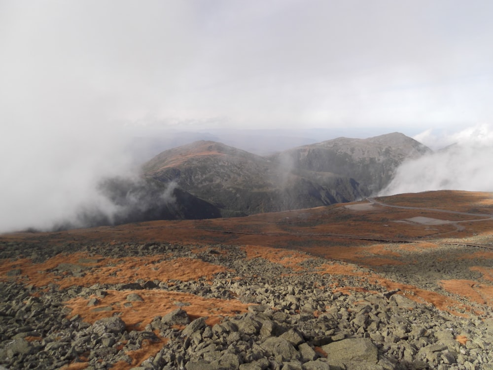 a view of a mountain range with low clouds