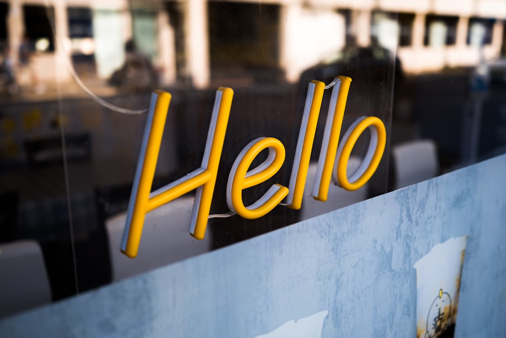 a close up of a glass door with the word hello on it