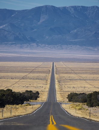 a long straight road in the middle of the desert