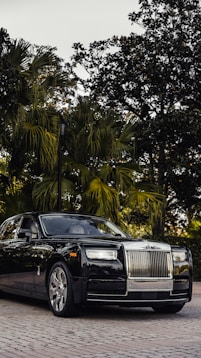 a black rolls royce parked in front of some trees on premium michelin tyres availabe at tyrepublic
