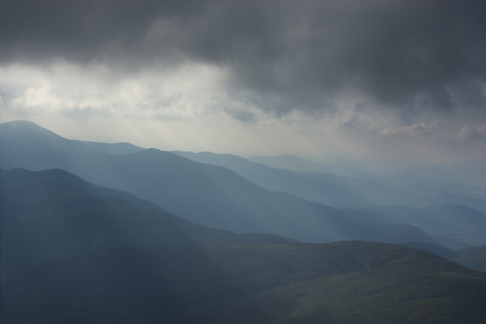 a view of a mountain range under a cloudy sky