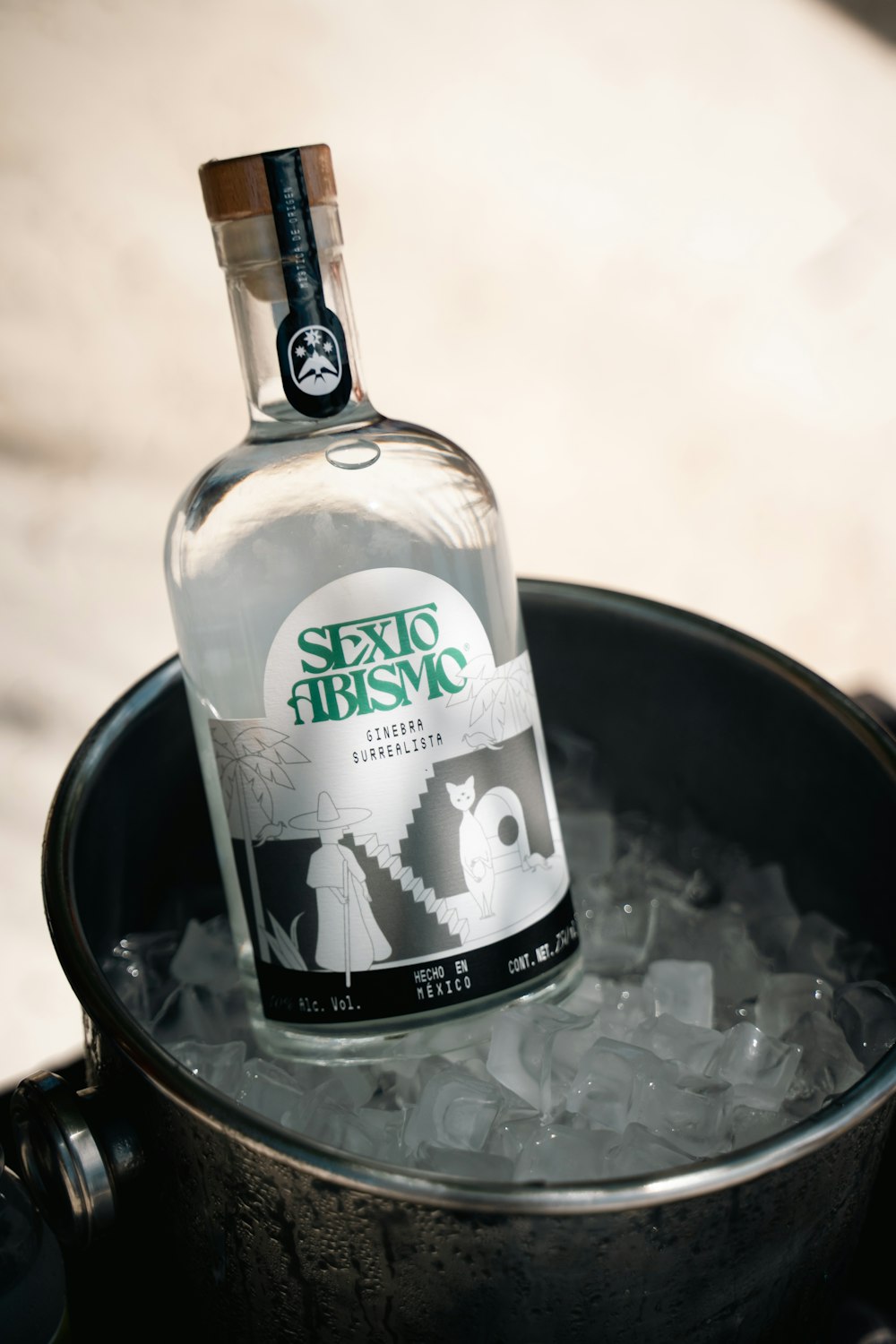 a bottle of alcohol sitting on top of ice in a pot