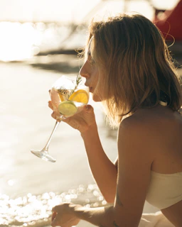 A traveler relaxing with a cocktail by a palm-lined beach, capturing a moment of calm.