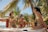 Three women in swimsuits are enjoying drinks while sitting in a hot tub surrounded by lush palm trees. The setting appears to be tropical, with clear blue skies and a wooden deck nearby.