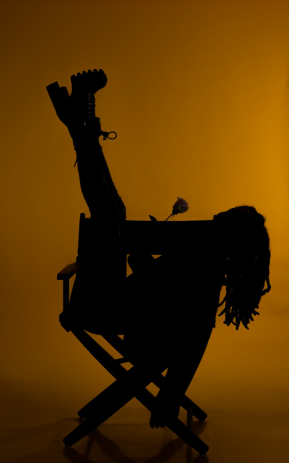 a silhouette of a person sitting in a chair