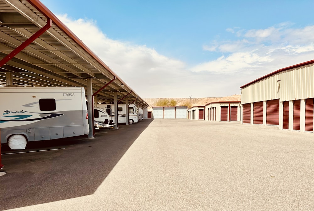 a row of parked motor homes in a storage area