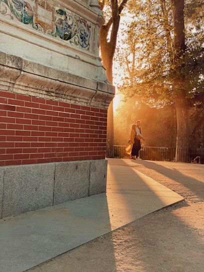 A warm sunset casting golden light over the nof yam community synagogue entrance, with families arriving for evening prayers.