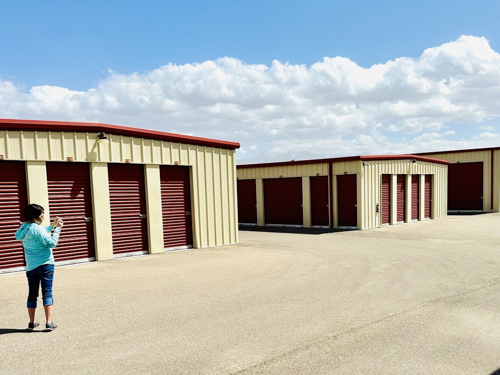 a woman standing in front of a storage unit