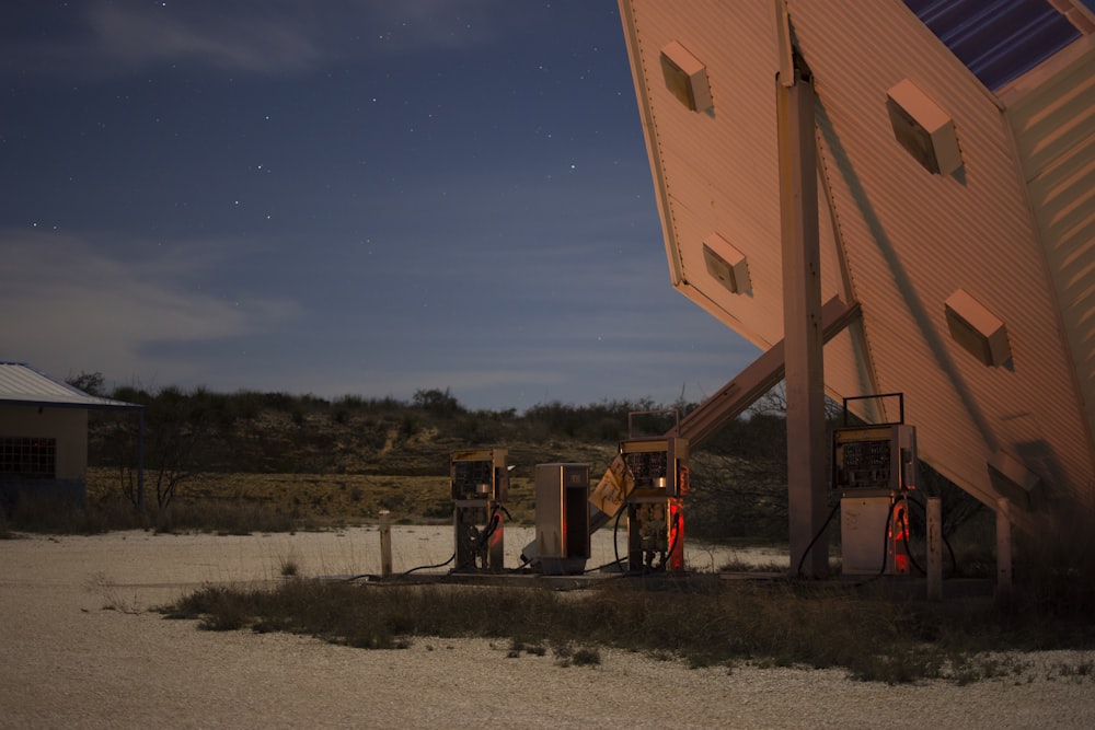 a gas station at night with the moon in the sky