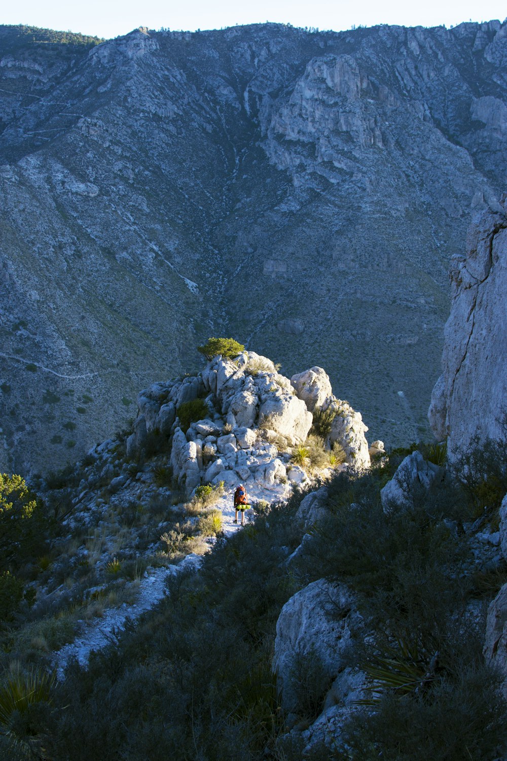 a person standing on a rocky mountain top