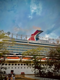 a large cruise ship with people standing on the deck