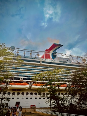 a large cruise ship with people standing on the deck