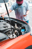 a man is working on a car engine