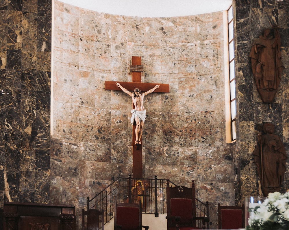 a crucifix on a stone wall in a church