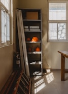 a room with a table and a shelf filled with oranges