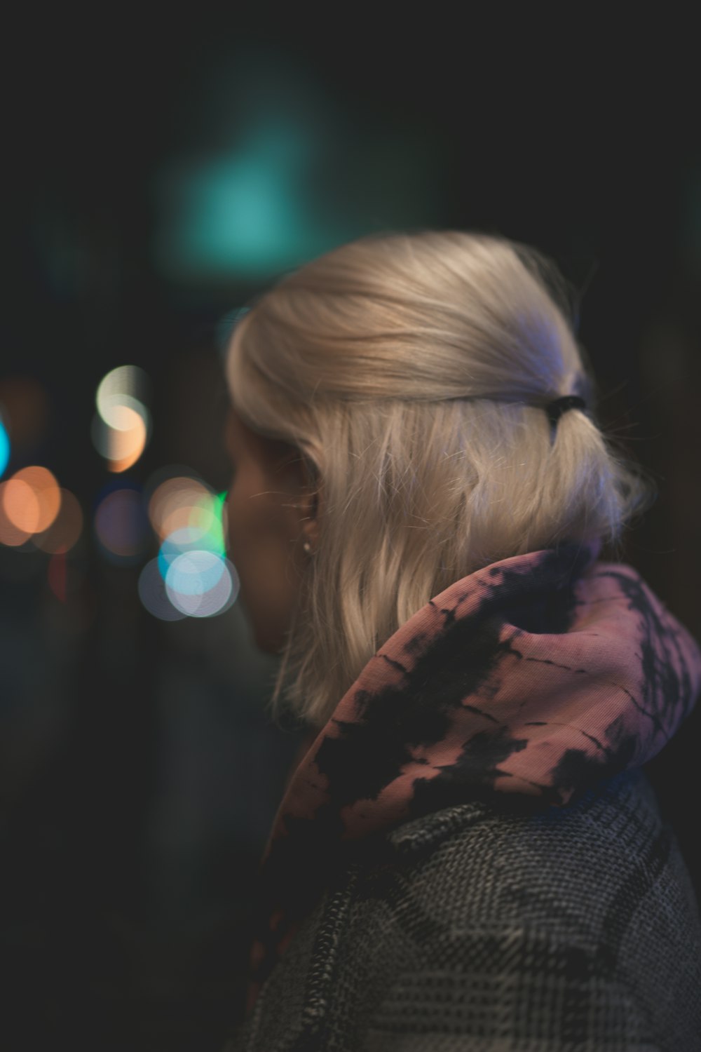 a woman with blonde hair wearing a scarf