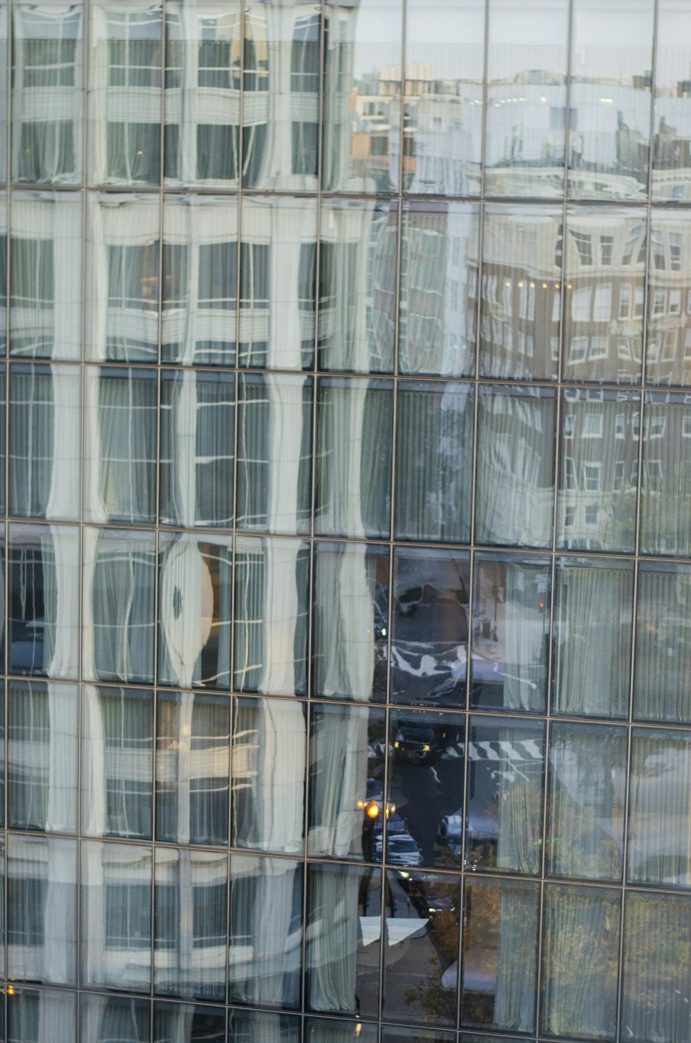 a reflection of a building in a glass building