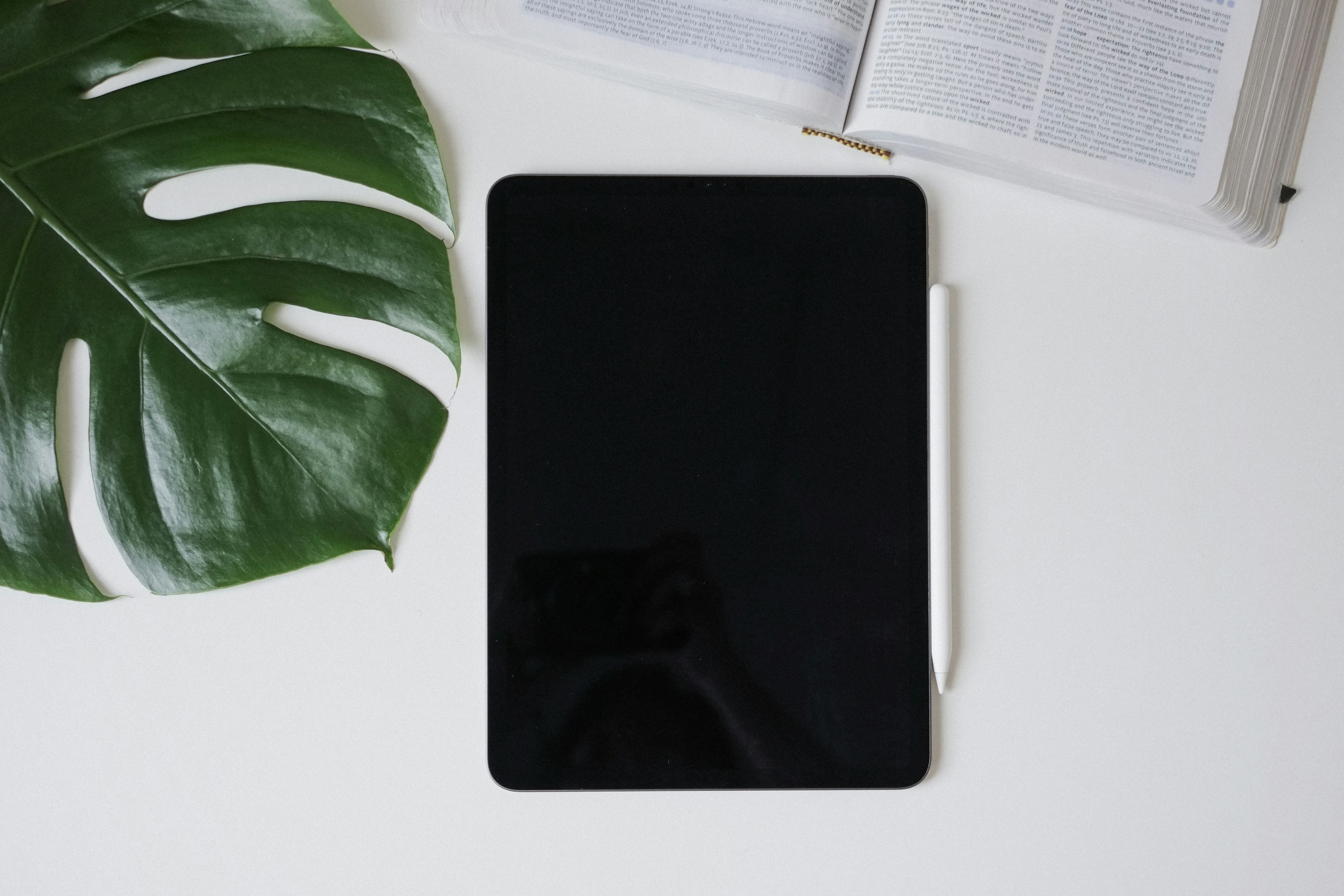 a cell phone sitting on top of a table next to a book