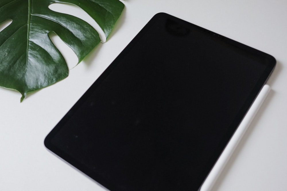 a tablet computer sitting on top of a white table