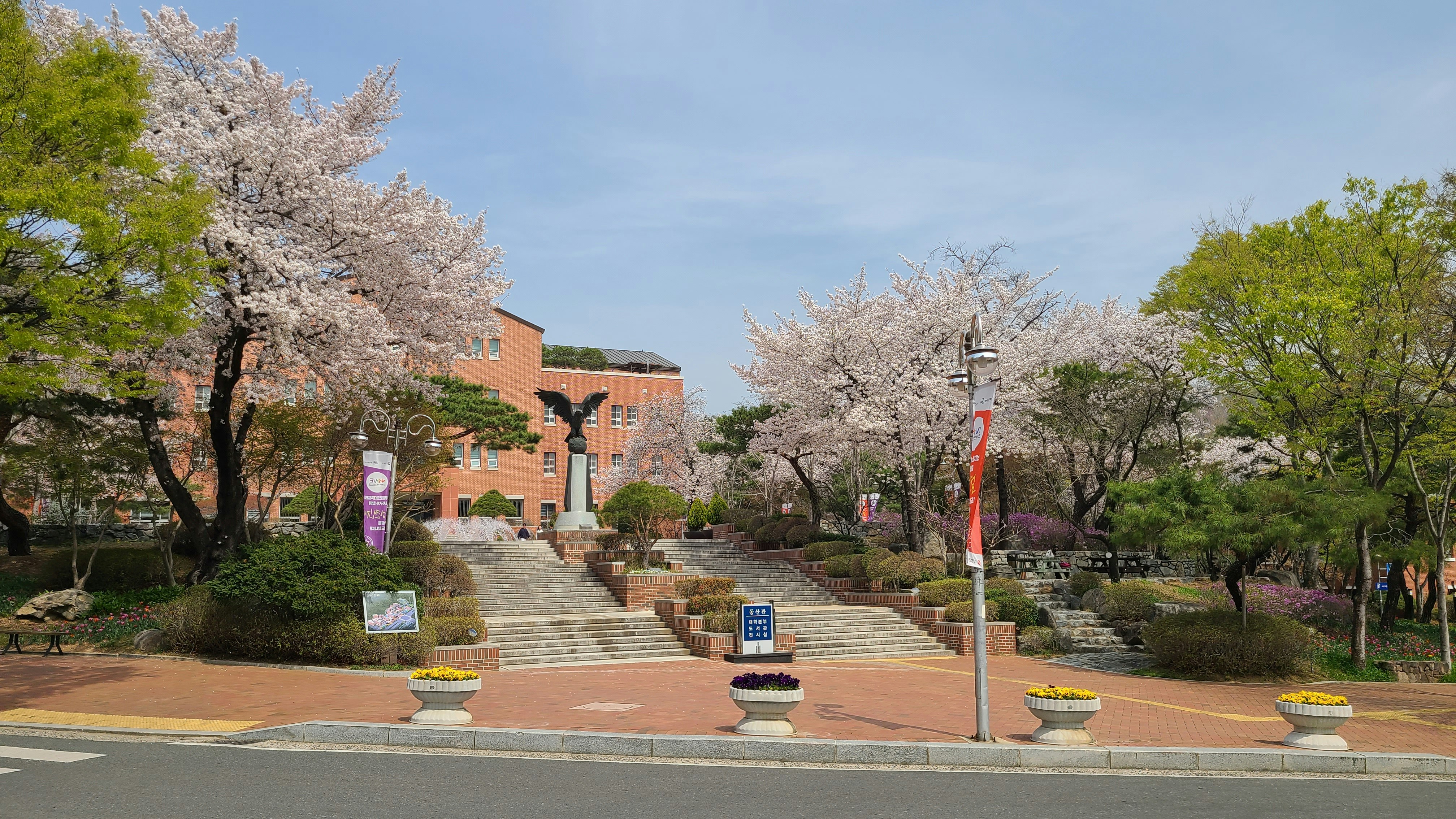 a large building with a lot of trees in front of it