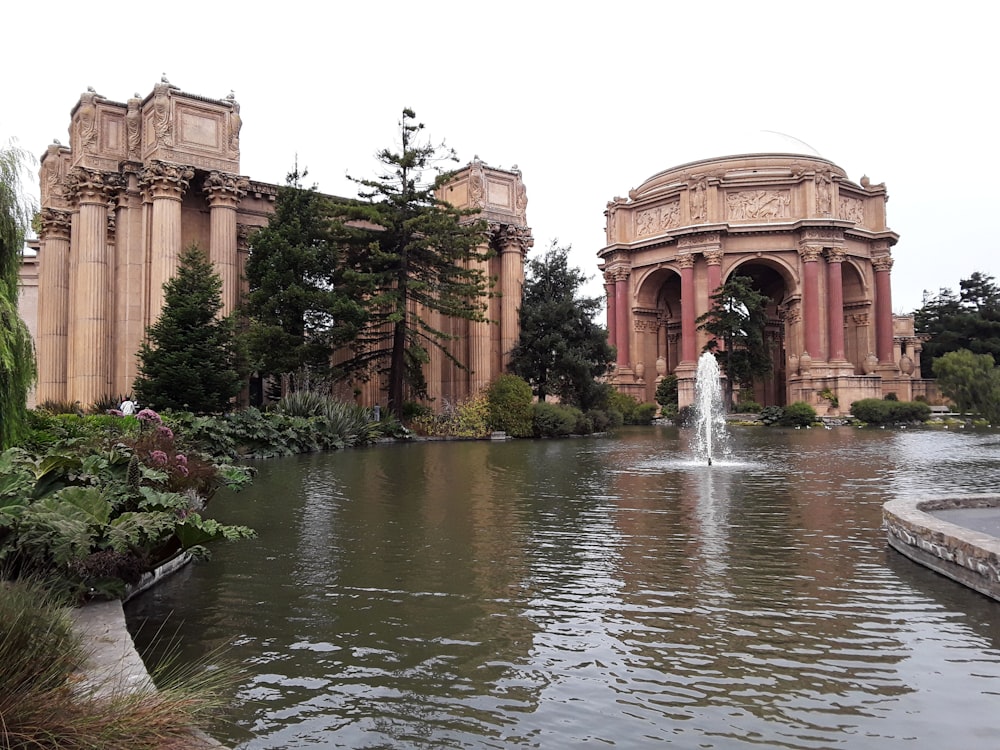 a pond with a fountain in the middle of it