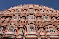 a tall building with lots of windows and balconies