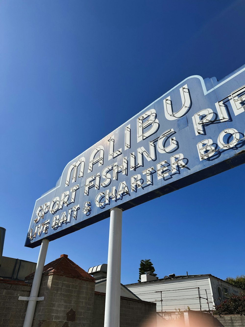 a sign for a fishing boat on a pole