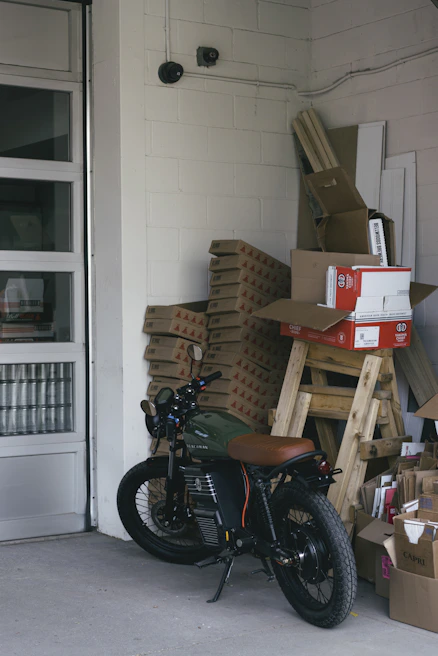 Close-up of a motorcycle securely stored on high metallic shelves in a clean, organized space