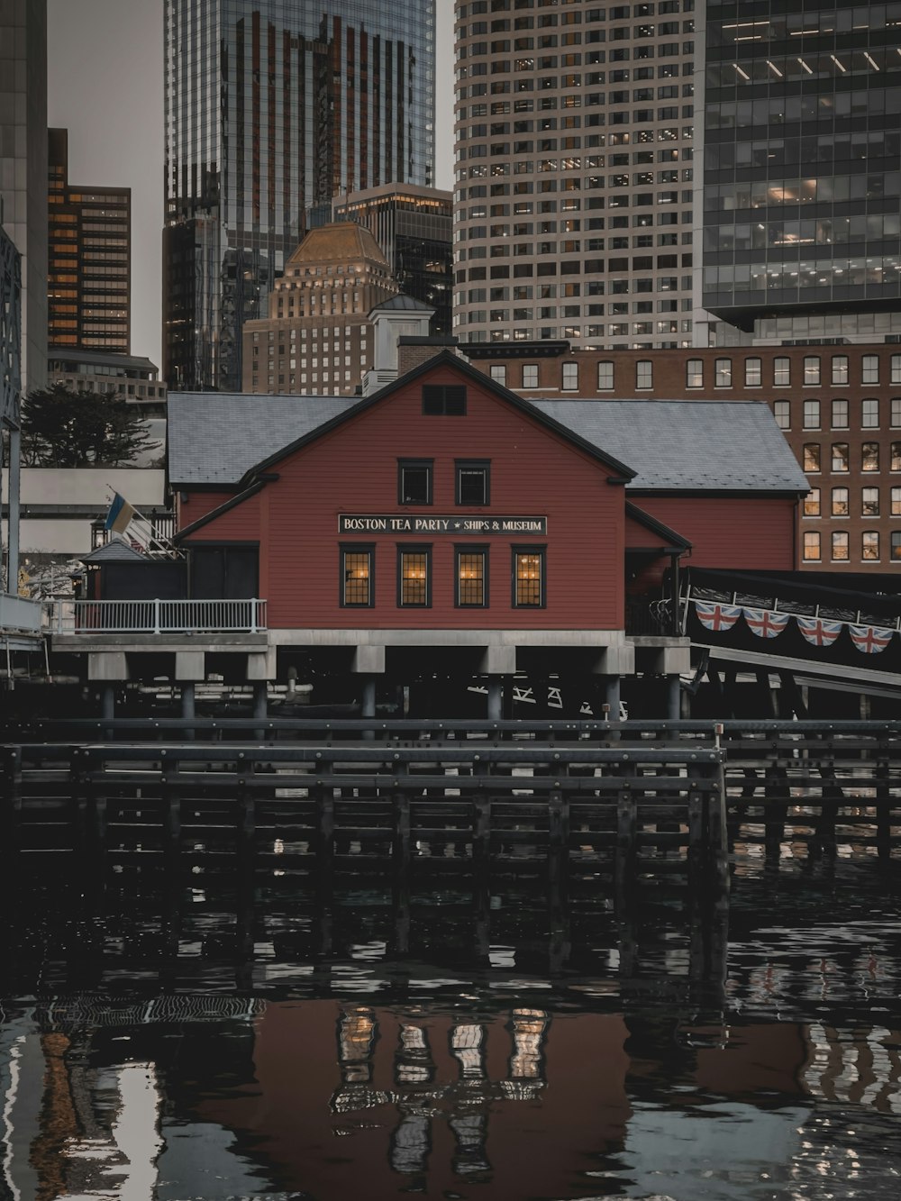 a red building sitting next to a body of water