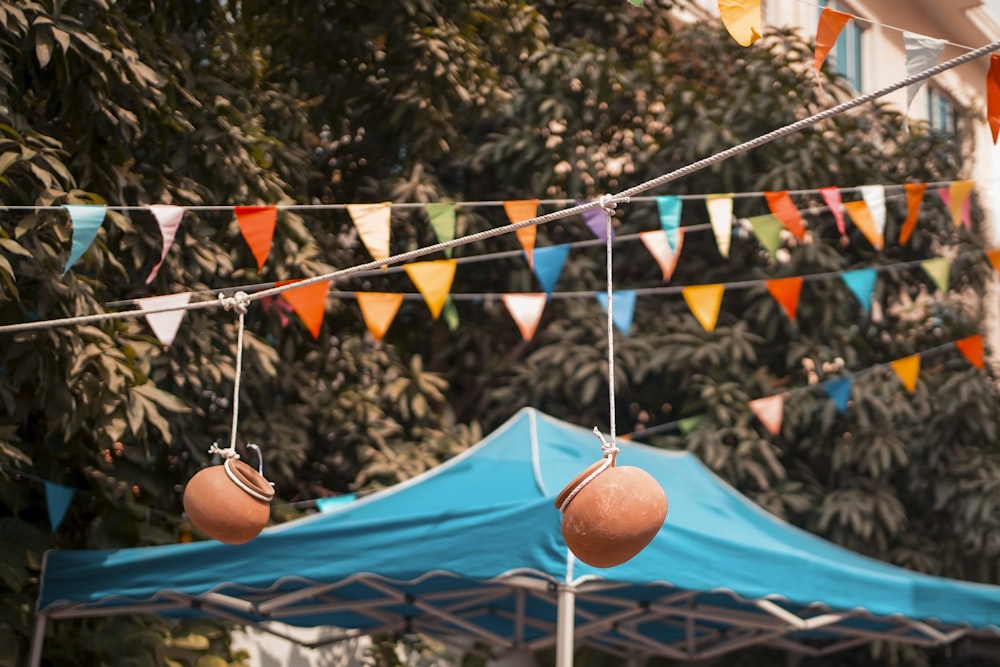 a blue tent with a bunch of flags hanging from it