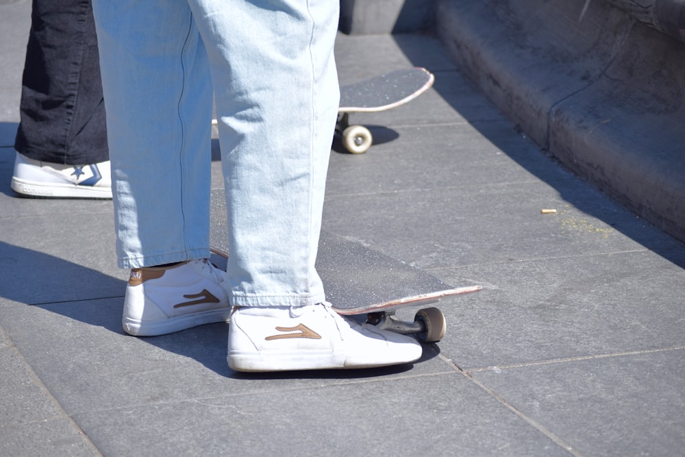 a person standing on a skateboard on a sidewalk