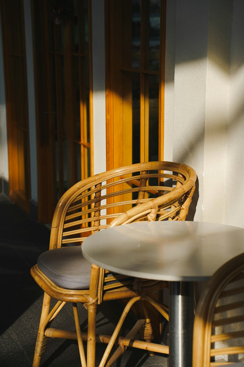 two chairs and a table outside a building