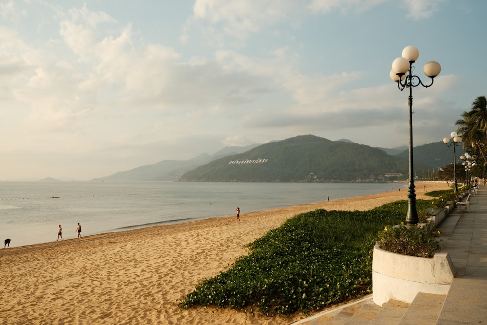 a view of a beach with people walking on it