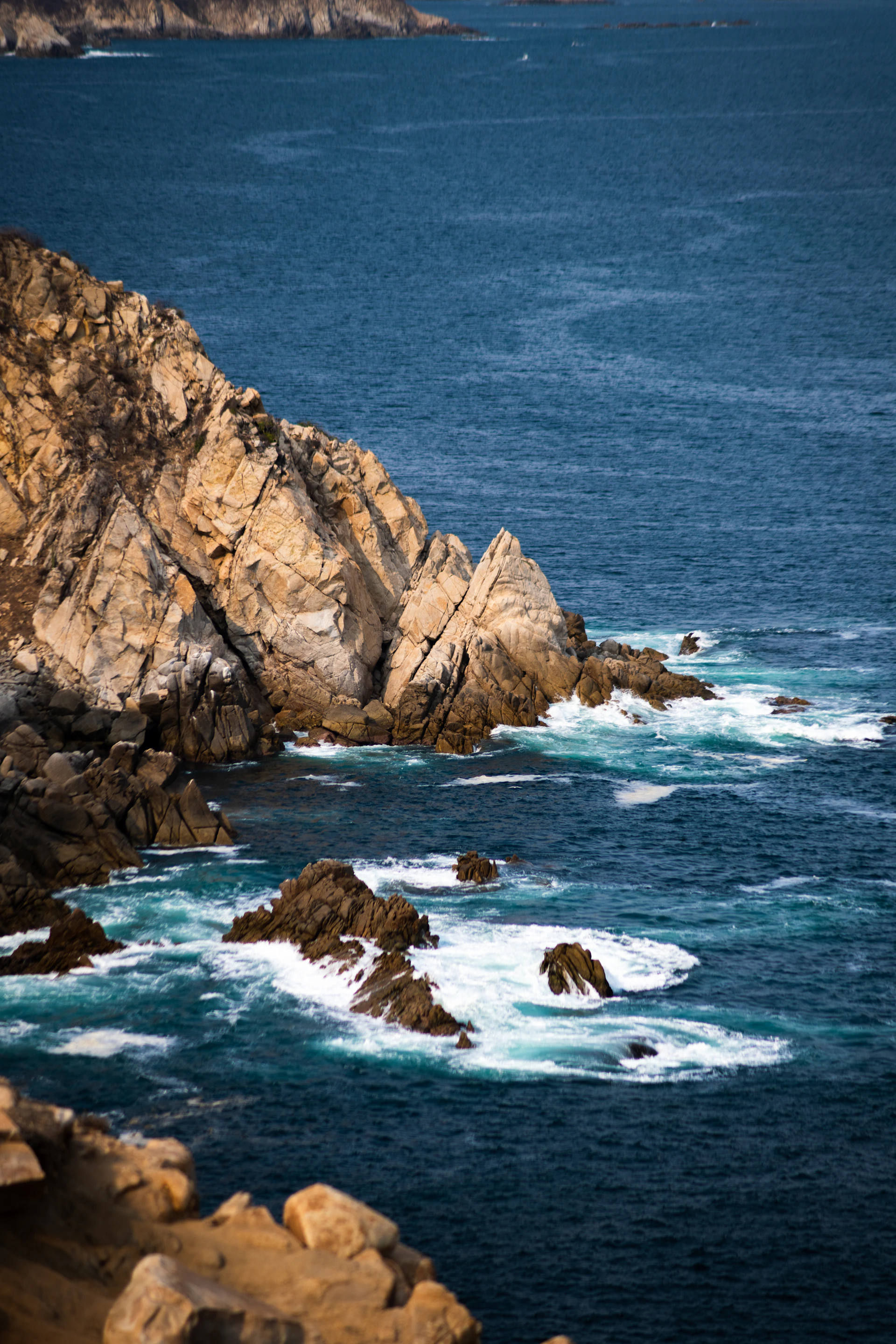 a large body of water next to a rocky shore